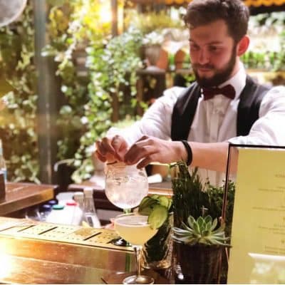 Cocktail bartender working in front of guests