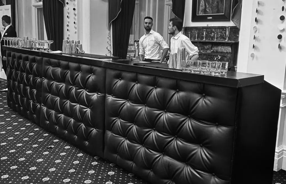 Black chesterfield mobile bar with staff in place
