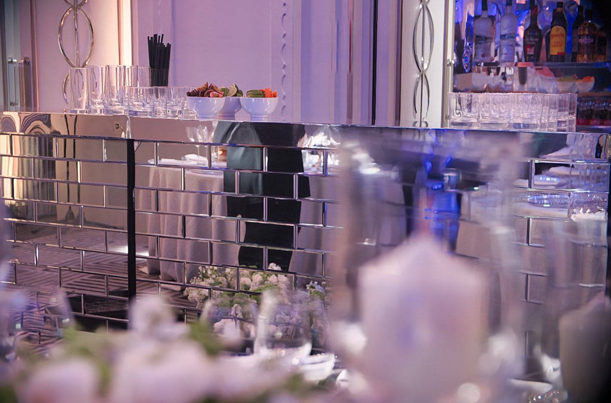 Mirror mobile bar frontage inside a formal event room